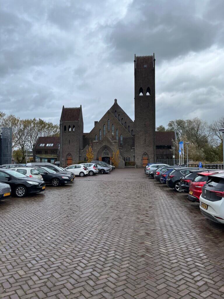 Church in parking lot with cloudy skies
